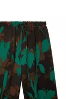 Emerald green and black floral silhouette print trousers  image